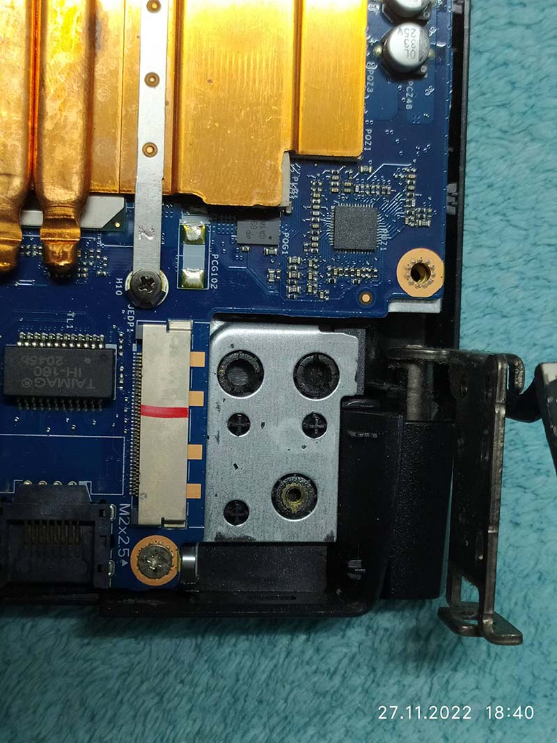 Detailed image of the Acer laptop's hinge mechanism and internal structure, including the metallic support frame and circuit board. This photo is useful for understanding hinge replacement, internal laptop structure, or step-by-step disassembly procedures.