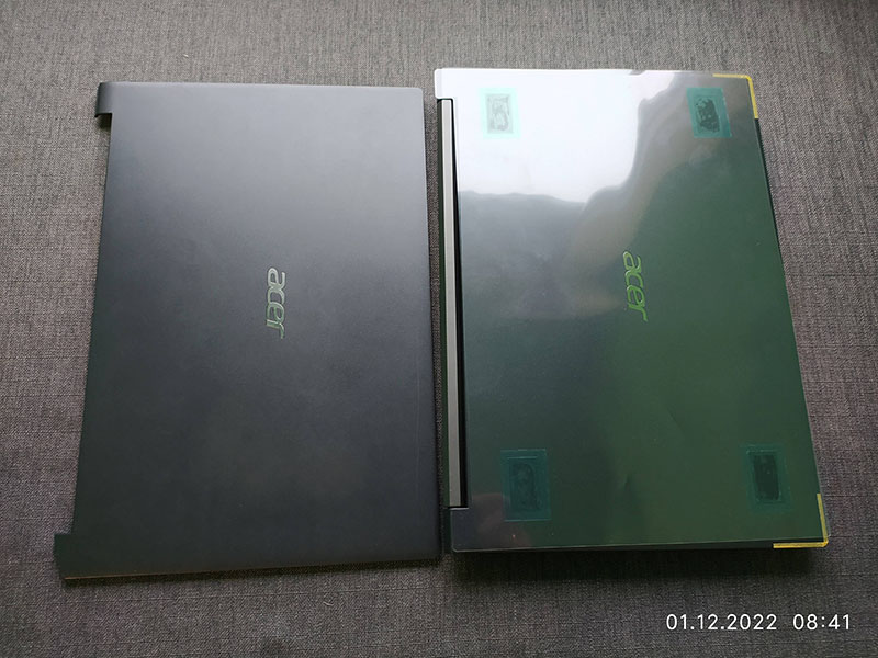 Side-by-side comparison of two Acer laptop screen lids, one with a matte finish and the other with a glossy, protective cover. This image helps users decide between different screen finishes when choosing laptop replacements or repairs.